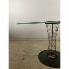 a table that has some wire on it and is in the middle of a room