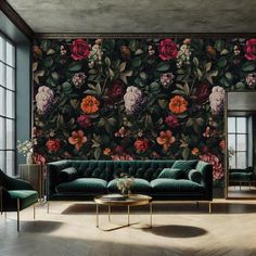 an elegant living room with floral wallpaper and green velvet couches, gold side tables and mirrors