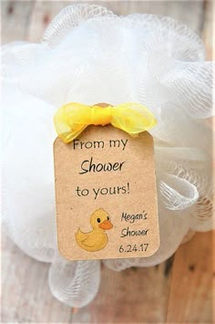 a rubber ducky with a yellow bow on it's head and tag that says from my shower to yours