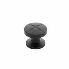 a black knob with an x design on the front and back end, is shown