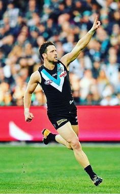 a male afl player in action on the field