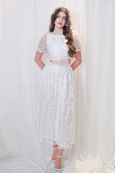 This midi set is the perfect addition to any stylish wardrobe. Made from high-quality lace material, this set features a-line skirt and short sleeves for a trendy and elegant look. Complete your outfit with this must-have set for a versatile and sophisticated style. Length- Top length: 32cm- Skirt length: 85cm White Lace Feminine Sets, Short Sleeve Lace Dress For Confirmation, Short Sleeve Lace Confirmation Dress, White Lace Knee-length Skirt, Elegant White Short Sleeve Sets, Types Of Lace, Mean Blvd, Stylish Wardrobe, Elastic Waist Skirt