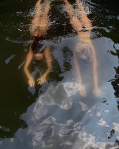 two people are swimming in the water together