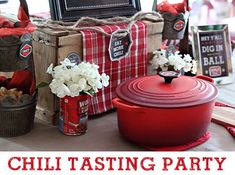 the table is set up with red and white decorations, including an old fashioned casserole dish