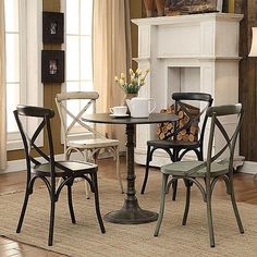 a dining room table with chairs and a fire place in the back ground, next to a fireplace