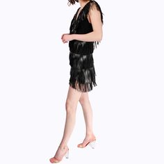 Vegan leather fringe high-low mini dress  Made of vegan leather fringe this look is rocker chic! The plunging neckline is balanced off with a more relaxed high-low skirt. The back neckline matches the front to create a V-open back. Outer 100% Polyester/ Lining: 100% Silk Do Not Machine Wash/ Delicate Dry Clean/ Do Not Bleach/ Do Not Tumble Dry Chic Fringe Flapper Dress For Party Season, Mini Flapper Dress With Fringe For Party Season, Party Season Fringe Mini Dress, Club Mini Dress With Fringe For Party Season, Beaded Fringe Flapper Dress For Cocktail, Summer Mini Flapper Dress For Club, Glamorous Fringed Flapper Dress For Clubs, Glamorous Fringe Flapper Dress For Club, Fringed Mini Dress For Night Out