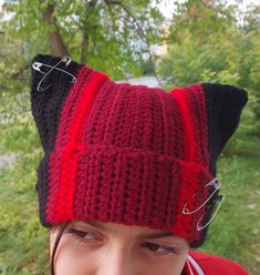 The Twenty One Pilots Inspired Clancy Black and Red Hat is the perfect accessory for any fan of the popular band. This unique crochet cat beanie features a handcrafted design that is sure to stand out. With the  bold colors, this beanie is a must-have for any music lover. Not only is it stylish, but it also doubles as a functional balaclava ski mask, keeping you warm and cozy in colder weather. Made with care and attention to detail, this Clancy beanie is a one-of-a-kind piece that will make you feel like a true member of the Clique. Add it to your collection or gift it to a fellow fan.  Hat composition; wool, acrylic  Choose your size from the list and specify it! All my products are made by hand in a non-smoking house. Care of hats; Hand wash in warm water, with special detergents. Color Balaclava Mask, Ski Mask Crochet, Crochet Ski Mask, Ski Mask Beanie, Crochet Cat Beanie, Knitted Ski Mask, Cat Ear Ski Mask Crochet, Red And Black Cat Beanie, The Clique