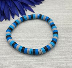 Select a bracelet length. This bracelet comes as a stretch / elastic only (no clasp). Beads include: 6x1mm heishi polymer clay beads in light blue, dark blue, gray, and black. Bracelet is handmade and new. Please realize that the bracelet may vary slightly from the one pictured based on the different lengths and / or clasps chosen. Please see sizing details in shop FAQ.  Is this a gift? Don't know their bracelet length? The average bracelet length for teens is 6.5 inches.  The average bracelet l Clay Bead Bracelet Ideas For Men, Dark Blue Clay Bead Bracelet, Men Beads Bracelet, Boy Clay Bead Bracelet Ideas, Clay Bead Bracelets For Boys, Boy Clay Bead Bracelet, Boy Bracelet Ideas, Clay Bead Bracelet Ideas For Boys, Bracelet Ideas For Boys