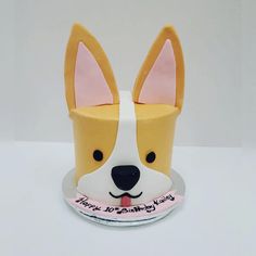 a cake shaped like a dog's head on a plate