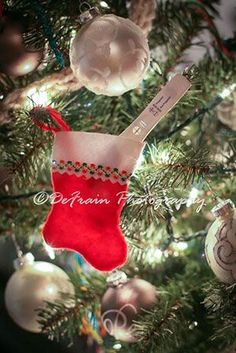 an ornament hanging from a christmas tree in the shape of a stocking