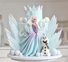 a frozen princess cake with frosting and decorations