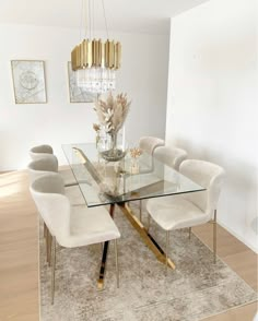 a dining room table with chairs and a chandelier