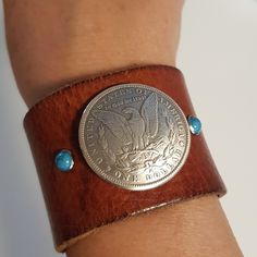 Made With Real Cowhide Leather, Features A U.S. One Dollar Concho With Two Turquoise Beads. Nice And Wide 2"X9". Gorgeous! Brown Concho Bracelets As Gift, Adjustable Concho Cuff Bracelet Gift, Unique Concho Bracelets For Gift, Unique Concho Bracelets As Gift, Unique Concho Bracelet As A Gift, Adjustable Concho Cuff Jewelry, Adjustable Stamped Turquoise Bracelets, Adjustable Turquoise Stamped Bracelets, Turquoise Concho Cuff Bracelet Gift