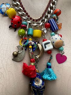 Fabulous hand created necklace!  Everything is intact . Charms include the letters L & I believe an E . There are 4 Cloissone parts including the fish, the rest are ceramic, fabric, plastic and a bit of bling in there also.  Fob fastener . Length is 47cm in total. Multicolor Dangle Charm Necklaces With Dangling Charms, Multicolor Dangling Charms Necklace, Multicolor Dangling Charm Necklaces, Whimsical Multicolor Charm Necklaces With Lobster Clasp, Whimsical Multicolor Necklaces With Charms, Unique Multicolor Charms Necklace, Unique Multicolor Necklaces With Charms, Handmade Bohemian Dangle Charms, Multicolor Charm Necklace