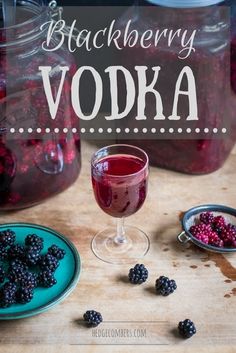 blackberry vodka in a glass next to some berries on a plate and another bowl with blackberries