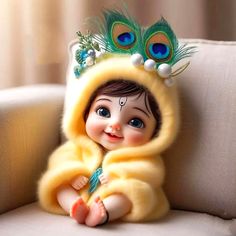 a baby doll wearing a yellow outfit with peacock feathers on it's head and feet