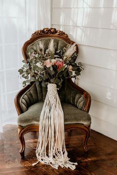 a bouquet of flowers is sitting on an old chair