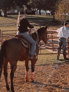 a woman riding on the back of a brown horse