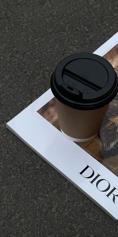 a coffee cup sitting on top of a magazine