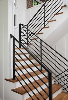 there is a black and white stair railing on the stairs