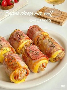 bacon cheese rice roll on a white plate with tomatoes in the backgroung