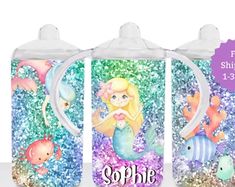 three sippy bottles with mermaids and sea animals on them, one has the word sparkle