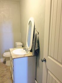 a bathroom with a sink, mirror and toilet