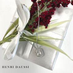 Make a statement in breathtaking luxury with this Henri Daussi Signed 1.14ct t.w. Diamond Cushion Brilliant Cut Halo Solitaire Pendant Necklace. Featuring premium quality natural diamond in a cushion-cut style, and a classic halo design, this luxurious necklace will become a treasured heirloom. Luxuriate in timeless elegance! Metal: 18K White GoldDiamond Shape: Cushion Brilliant CutDiamond Weight: Cushion Center Shape 1.01carat22 Round Brilliant Cuts: 0.13ct twChain Length: 16''- 17.5'' Estimated production time is 4 - 5 weeks. Luxurious Necklace, Necklace Guide, Henri Daussi, White Gold Pendant Necklace, Diamond Initial Necklace, Halo Design, Jewelry Appraisal, Solitaire Pendant Necklace, Bridal Engagement Rings