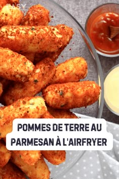 some fried food on a plate with sauces and ketchup in the background