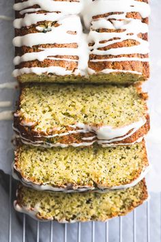 a loaf of lemon poppy seed bread with white icing on top and four slices cut off