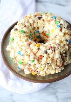 a sprinkled donut sitting on top of a plate covered in cereal krispy kreme