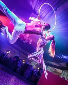 two circus performers performing aerial acrobatic tricks