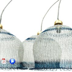 two silver and blue lamps hanging from strings on a white background with room for text