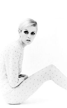 black and white photograph of a woman in pajamas sitting on the floor with her legs crossed