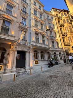 an old building with many windows and balconies on the side of it at dusk