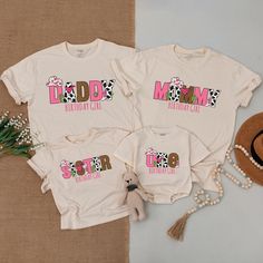 three t - shirts with the word udd'd mom printed on them next to a straw hat