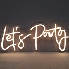 a neon sign that says let's party