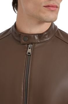 Ride off into the sunset in this sleek moto jacket expertly crafted from faux leather. 26 1/2" length Front zip closure Band collar Front zip pockets Lined 100% rayon with 100% polyurethane coating Spot clean Imported Moto Outerwear With Zipper Closure In Faux Leather, Moto Faux Leather Outerwear With Zipper Closure, Moto Outerwear With Zipper In Faux Leather, Solid Biker Outerwear With Zipper Closure, Biker Style Solid Outerwear With Zipper Closure, Sleek Leather Jacket With Zipper Closure, Spring Leather Outerwear With Zipper Closure, Brown Leather Jacket With Zipper For Work, Faux Leather Asymmetrical Zip Jacket