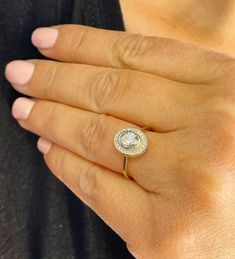 a woman's hand with a diamond ring on it