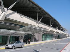 a car parked in front of an airport terminal