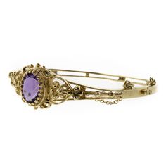 This is a perfect piece of fine jewelry history. A 14K yellow gold filigree bracelet with an oval 3.93ct amethyst secured by a stunning multi-prong setting. This bracelet has a fully functional hinge clasp and safety chain. The bracelet is in beautiful shape. Formal Purple Oval Cabochon Jewelry, Formal Amethyst Oval Cabochon Jewelry, Formal Amethyst Jewelry, Oval Cabochon, Heirloom Jewelry With Oval Jewels, Heirloom Oval Jewelry With Jewels, Ornate Bangle For Formal Occasions, Yellow Gold Oval Bangle With Gemstone, Ornate Formal Bangle Jewelry, Oval Cabochon Bracelet In Fine Jewelry Style