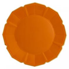 an orange plastic plate with scalloped edges