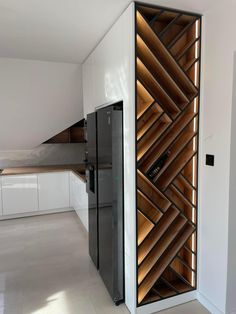 a kitchen with white cabinets and wooden shelves on the wall next to an open refrigerator