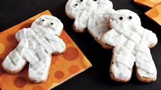 two decorated cookies sitting on top of a table