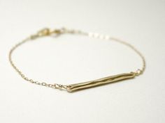 Gold bar bracelet - hammered bronze wire horizontal on gold filled chainThin bronze wire is hammered to create rough facets and polished to a bright shine.  14K gold filled chain finishes this minimal bracelet.  Simple and modern.>>>measurements<<inspired by this necklace!http://www.etsy.com/listing/91146648/gold-bar-necklace-hammered-brass-wire-on*please note -- bar is made of raw bronze and will darken over time, can be easily polished with polishing cloth or check policies for Minimalist Brass Chain Bracelet Gift, Minimalist Brass Chain Bracelet For Gift, Minimalist Hammered Gold Bracelets, Minimalist Handmade Gold Chain Bracelet, Gold Bar Bracelet, Minimal Bracelet, Bracelet Simple, Bar Bracelet, Gold Bar Necklace