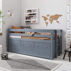 a child's bedroom with a bed, dresser and bookcase in grey tones