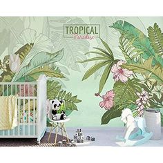 a baby's room decorated with tropical wallpaper