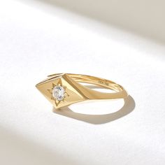 The Rhombus Northstar Signet Ring is a petite and elegant piece of jewelry that blends celestial motifs with geometric design. Crafted from high-quality 14k solid gold, this ring features a unique rhombus-shaped signet adorned with a small, sparkling diamond in the center. Features * Made to Order. * Gold KT: 10K, 14K, 18K * Width of Band: 1.87MM * Width of Top: 8.06x13.68MM * Thickness of Band: 1.31MM * Custom Gold Color: Rose Gold, Yellow Gold, White Gold * Diamond Color- Clarity: D-E-F color VVS clarity (excellent ideal cut) *Total Ctw: 0.12 ctw * Ready to Ship in 5-7 Business Days ✓ We care about the environment,the jewelry we cast is made with recycled gold. We source exclusively post-consumer material that is refined back to their pure elements to ensure that the gold is in the same Celestial Single Diamond Wedding Jewelry, Celestial Wedding Jewelry With Single Diamond, 14k Gold Celestial Diamond Ring, 14k Gold Single Diamond-shaped Jewelry, Celestial 14k Gold Diamond Ring, Celestial 14k Gold Ring With Single Diamond, Celestial Single Diamond Ring Gift, Celestial Single Diamond Promise Ring, Celestial Style Single Diamond Ring As Gift