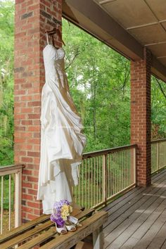 there is a white dress on the back of a statue in front of a brick building