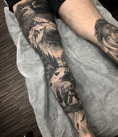 a man's leg with tattoos on it